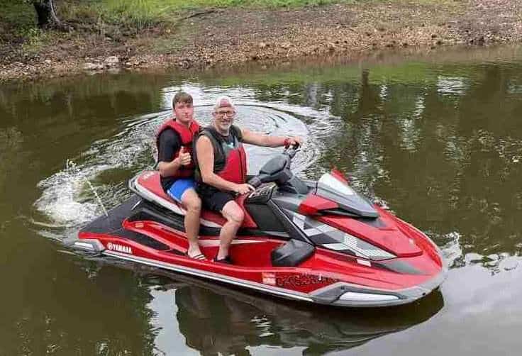 Guests riding a jet ski together on Grand Lake