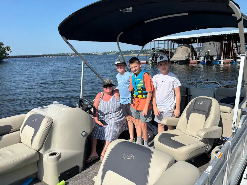 Group of guests aboard a Barletta tritoon on Grand Lake