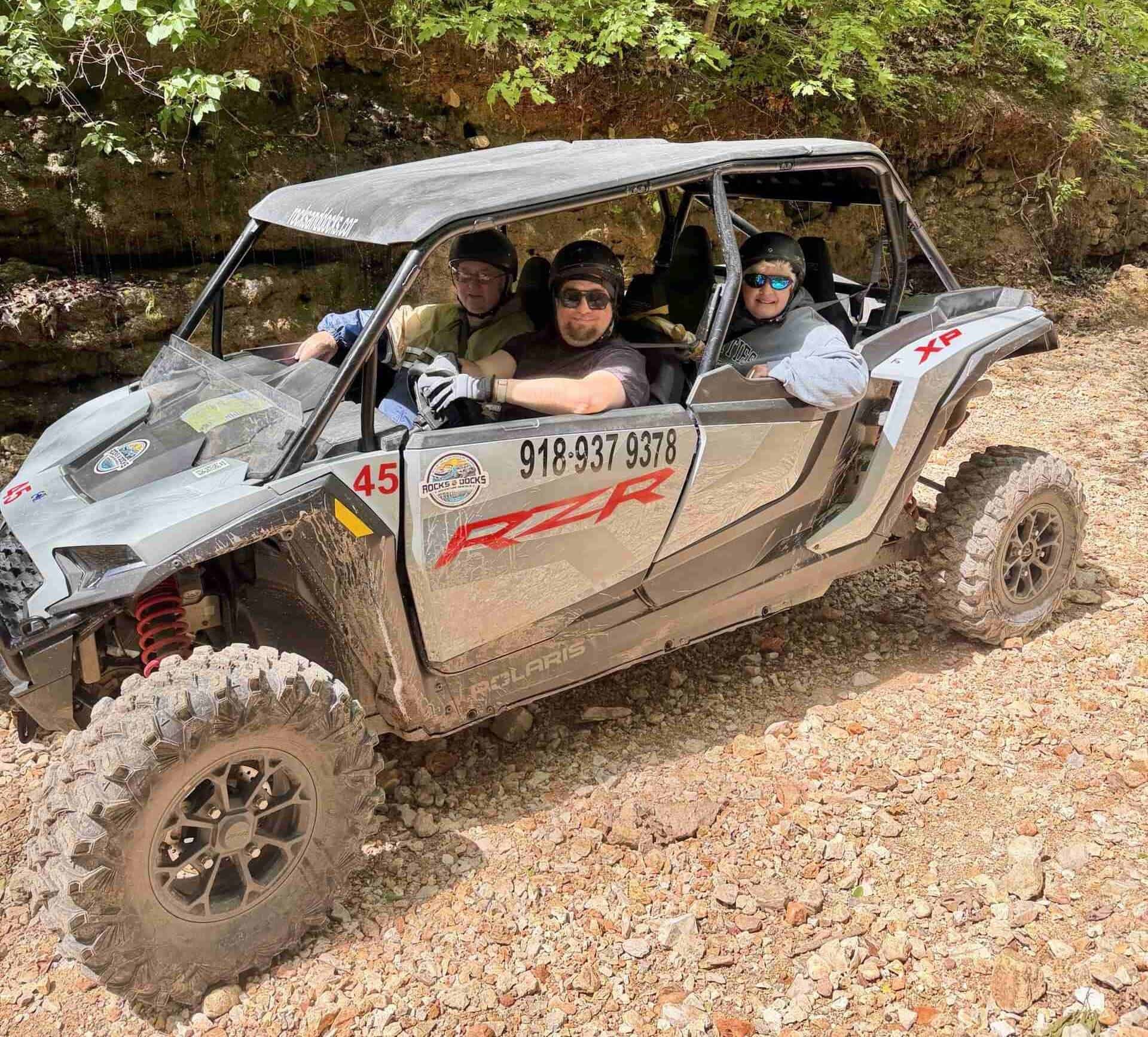 Polaris RZR navigating rocky off-road terrain near Grand Lake