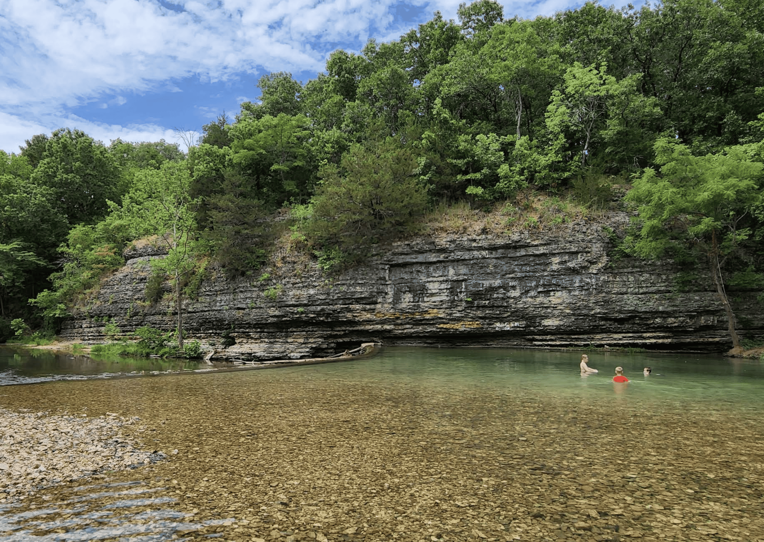Rocky shoreline and clear water at Little Blue State Park