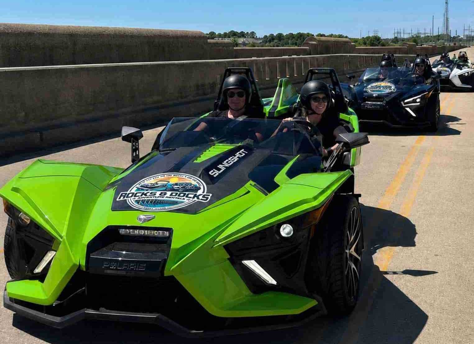 Three Polaris Slingshots driving during a scenic Grand Lake drive